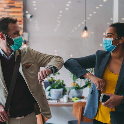 Business people greeting during COVID-19 pandemic, elbow bump